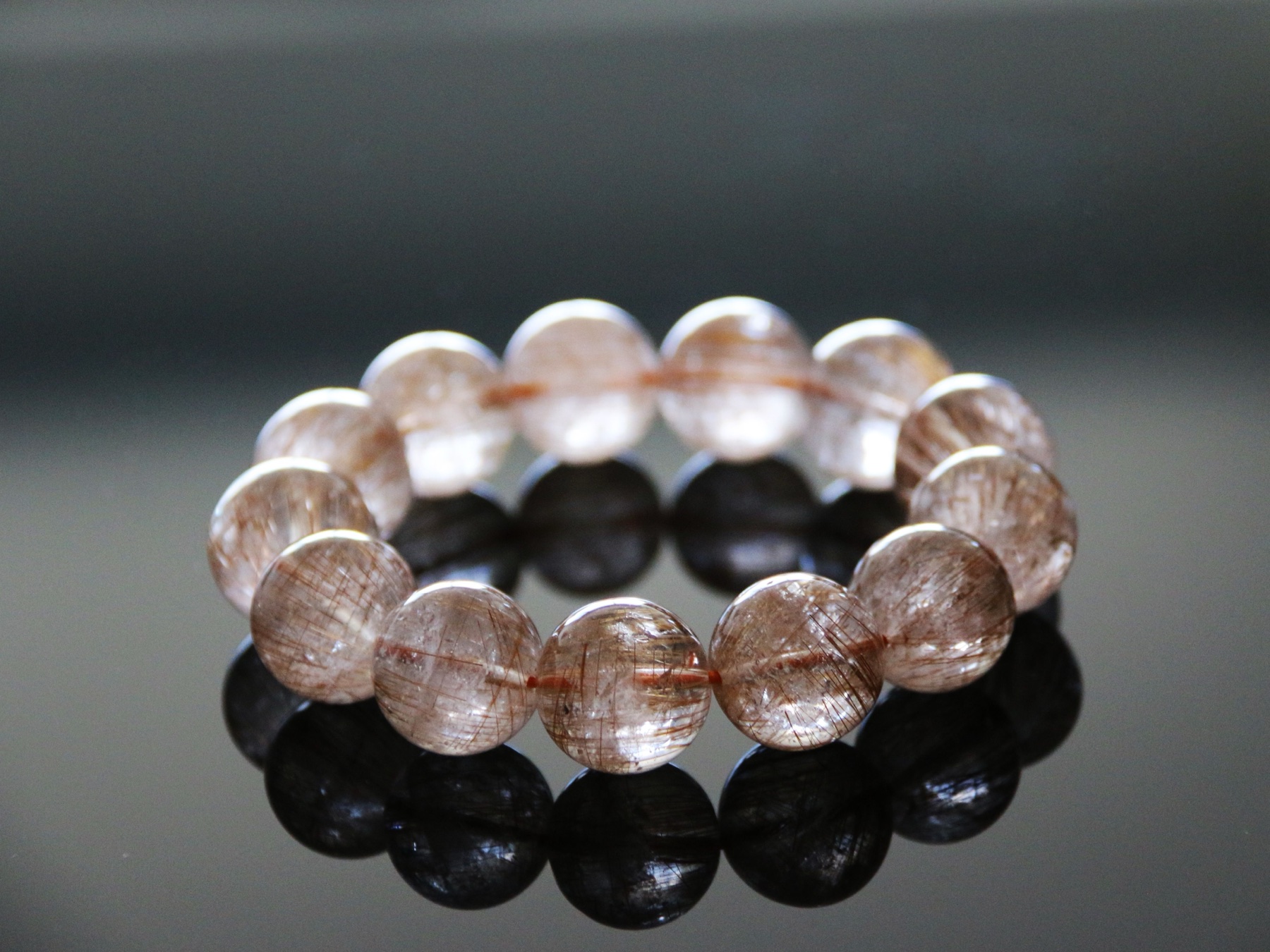 Editorial photograph of a real crystal beaded bracelet on a dark surface